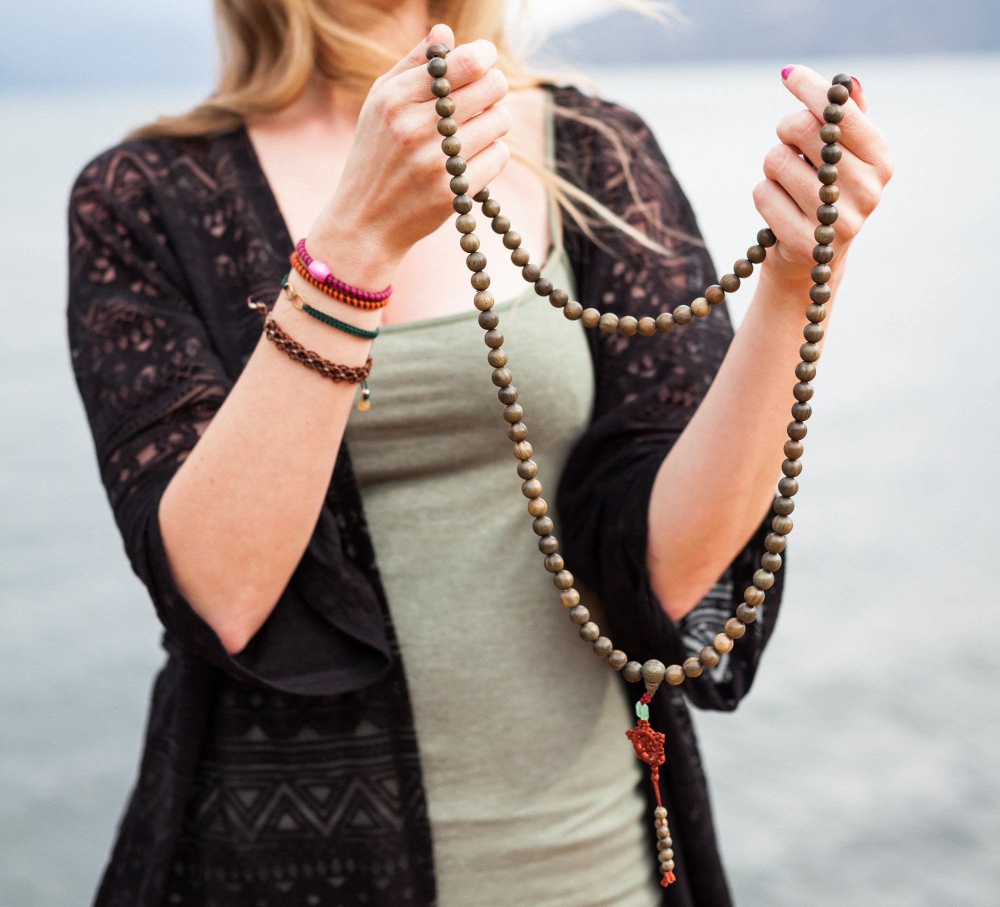 Holding the 10mm Giant Green Sandalwood Mala